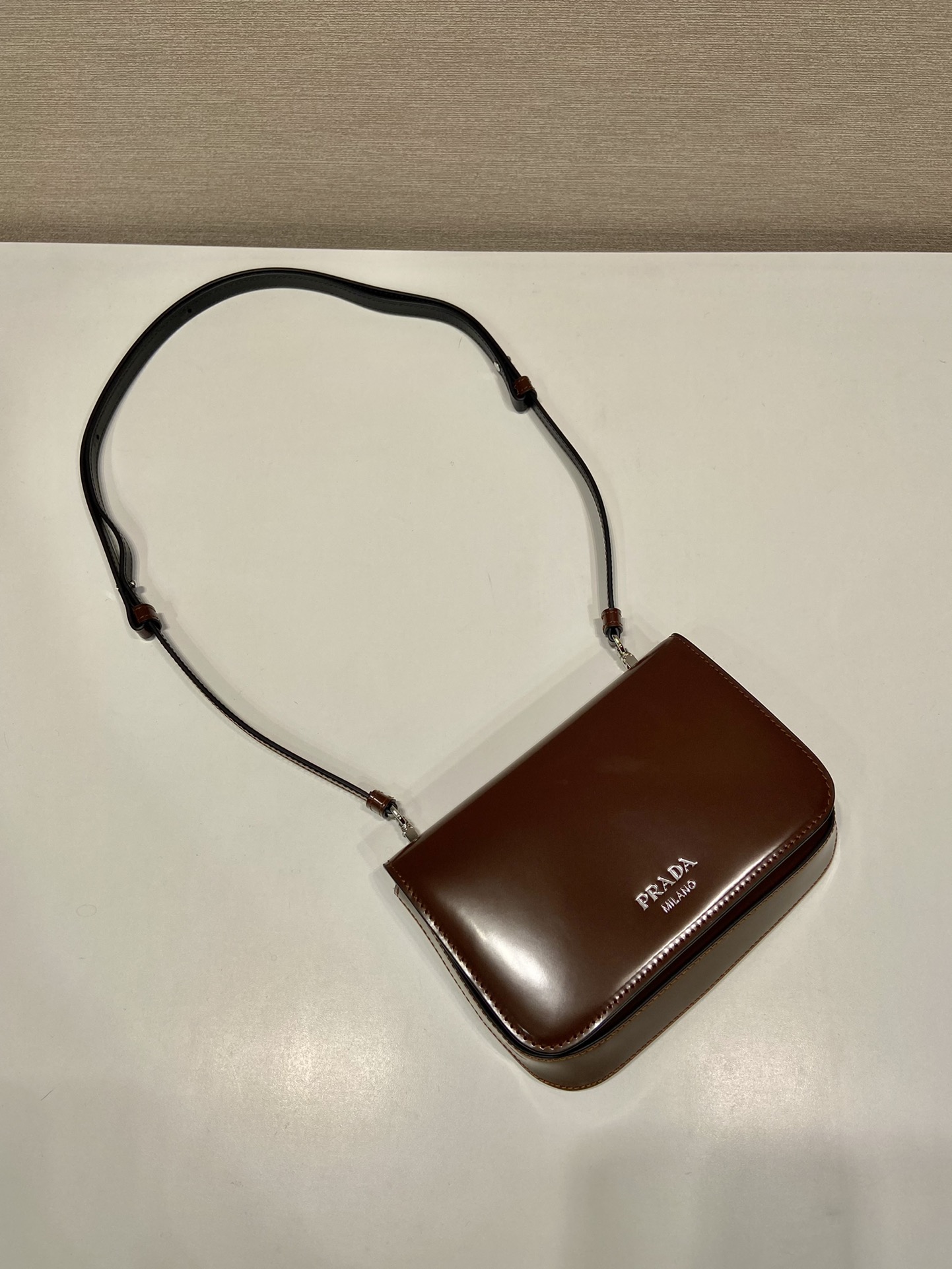 Pra*a brushed leather mini-bag with shoulder strap